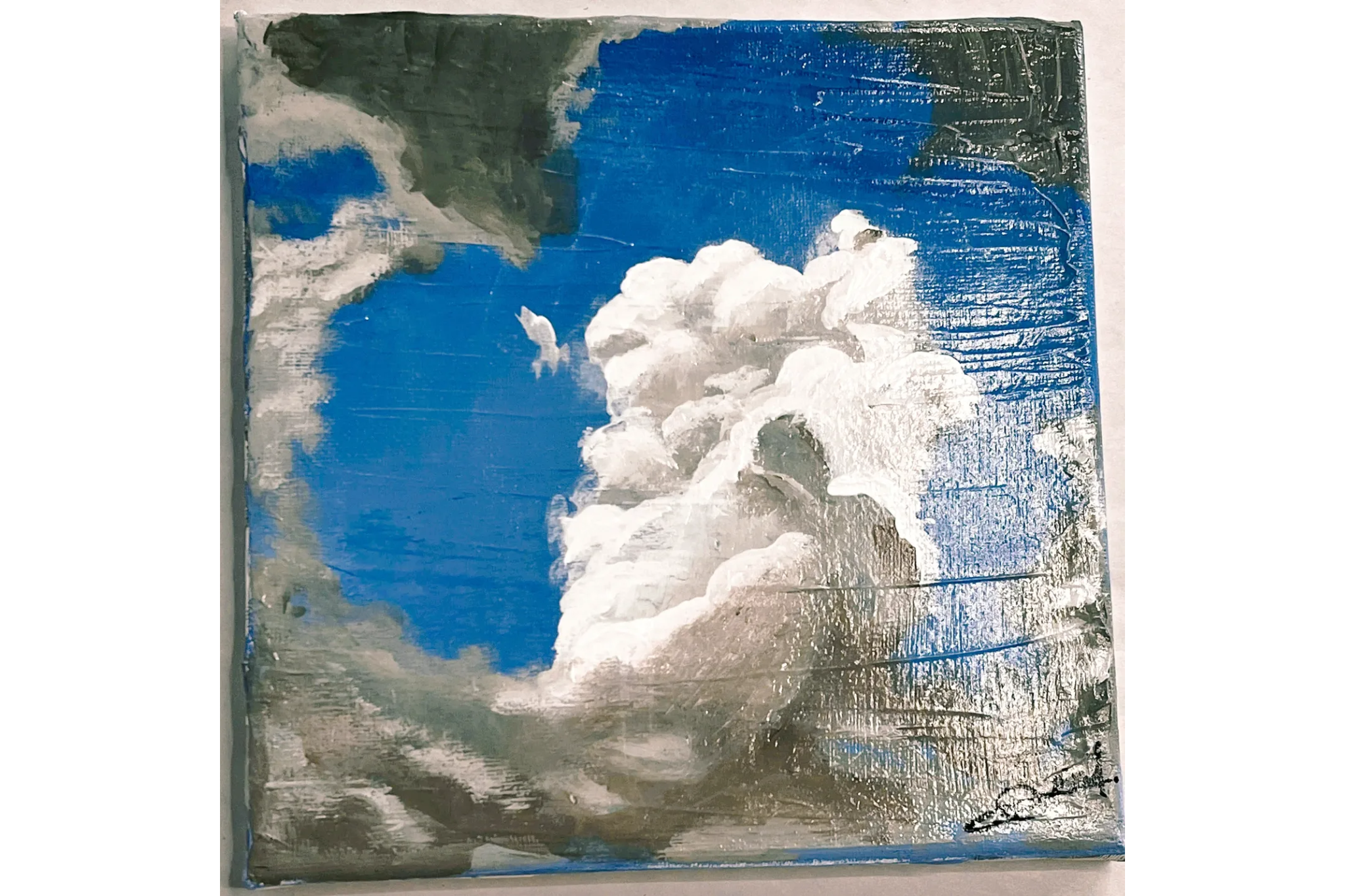 A vivid blue sky with large, fluffy white clouds.