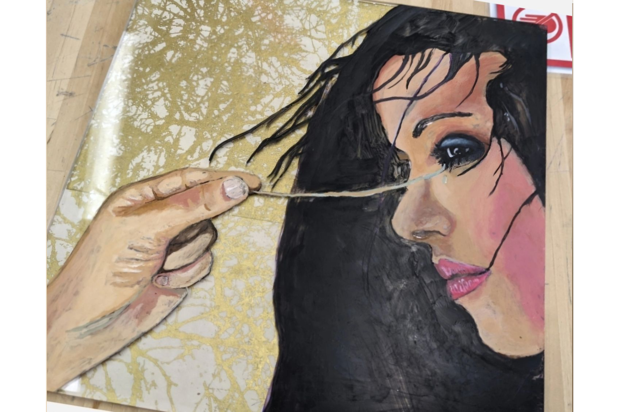 A hand measuring a woman's face with a string against a decorative background.