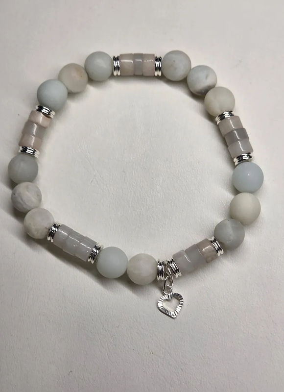 Elegant beaded bracelet with silver accents and a heart charm.