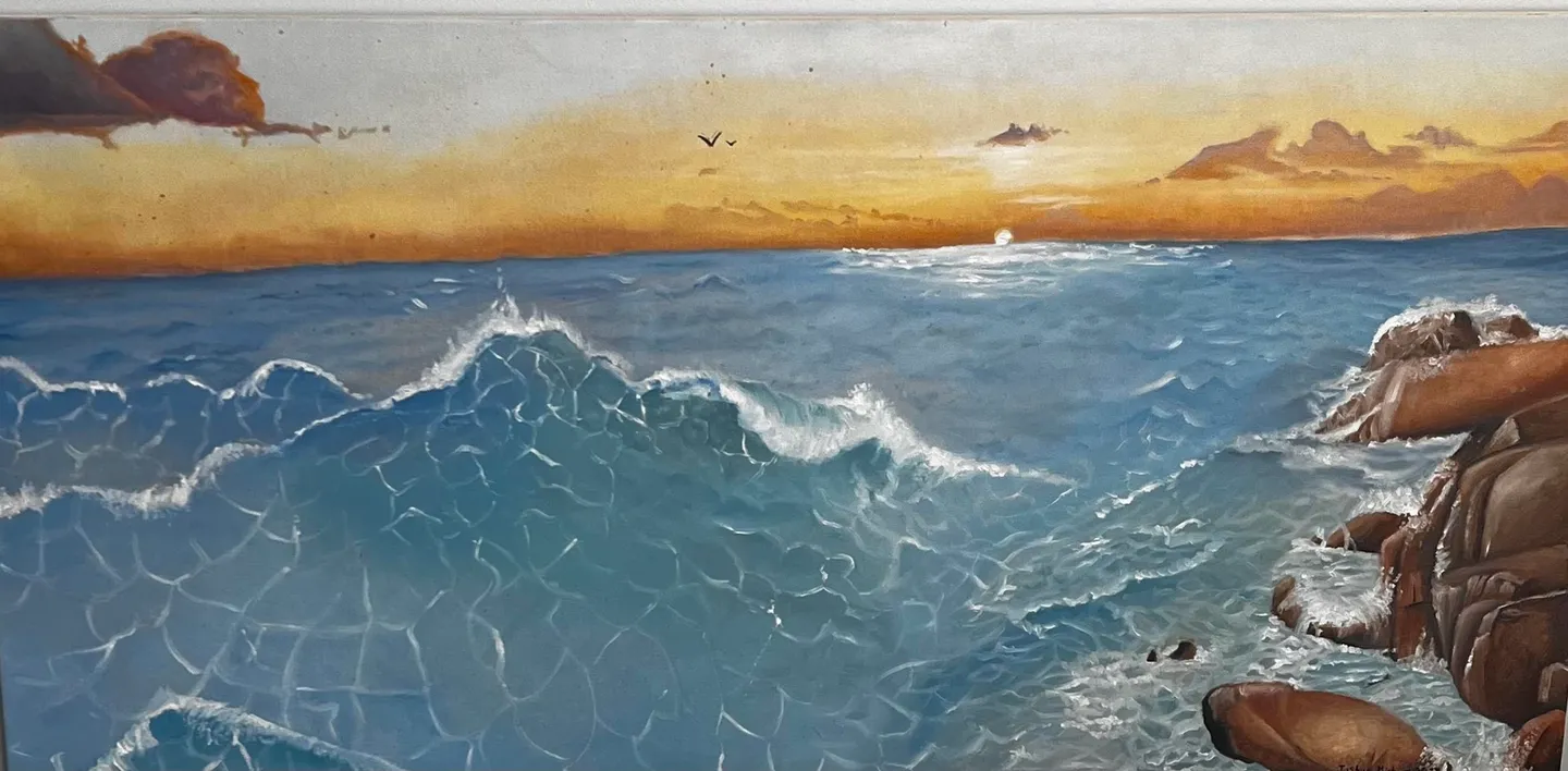 A serene sunset over a gently crashing ocean wave.