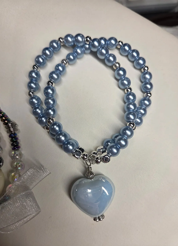 Blue pearl necklace with a heart-shaped pendant.
