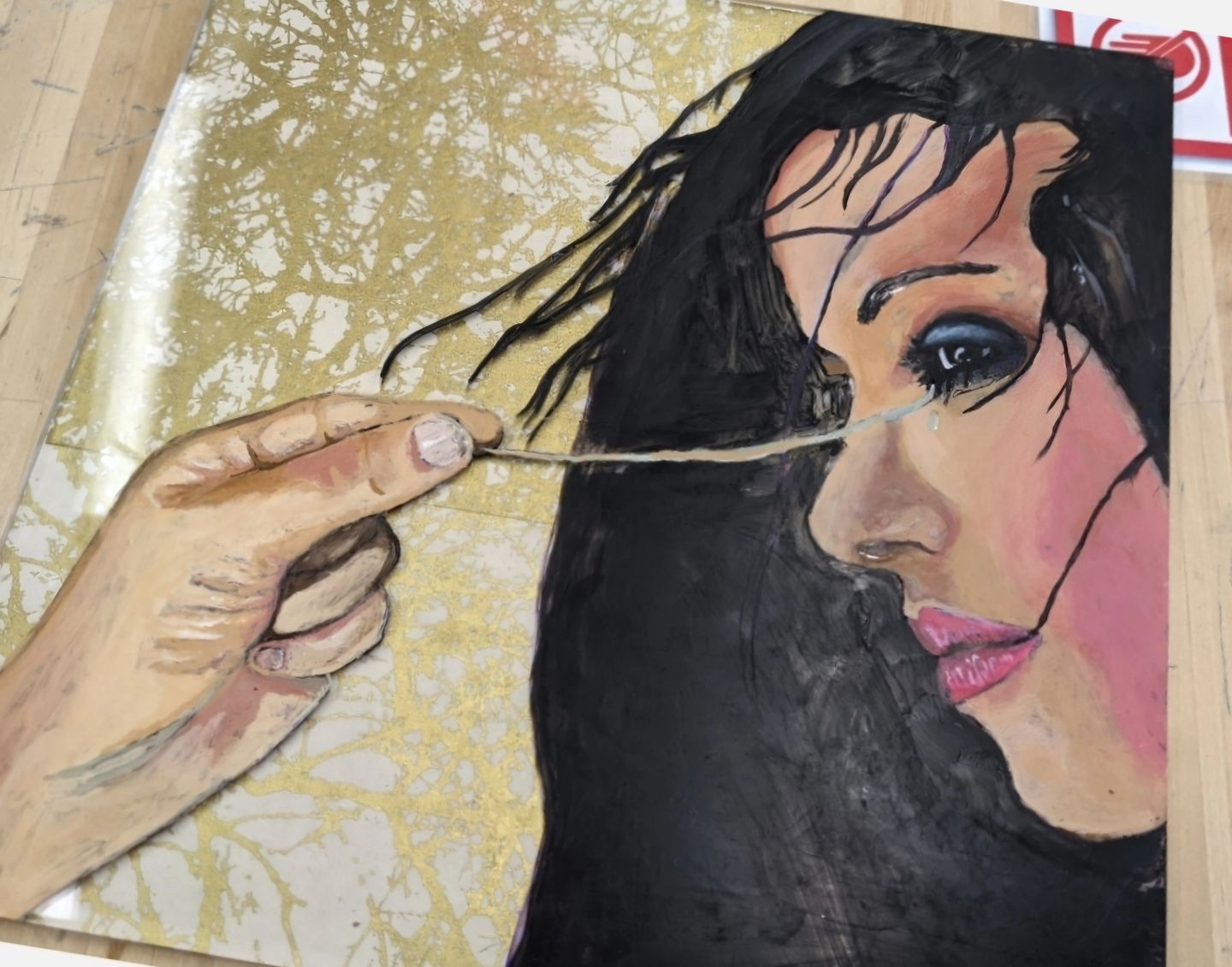A hand pulling a string near a woman's face in an artistic style.