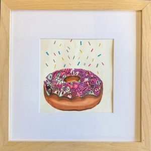 A framed watercolor painting of a pink-frosted donut with sprinkles.